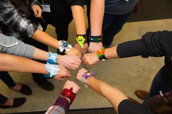 students show off their soft circuit bracelets