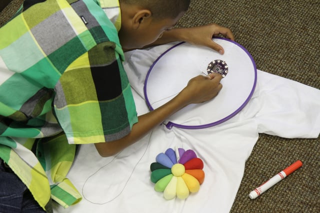 young boy sewing e-textiles with LilyPad