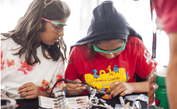 two students soldering